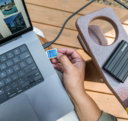 hand-inserting-sd-card-into-laptop-next-to-external-hard-drive-.jpg Hand inserting sd card into laptop next to external hard drive.